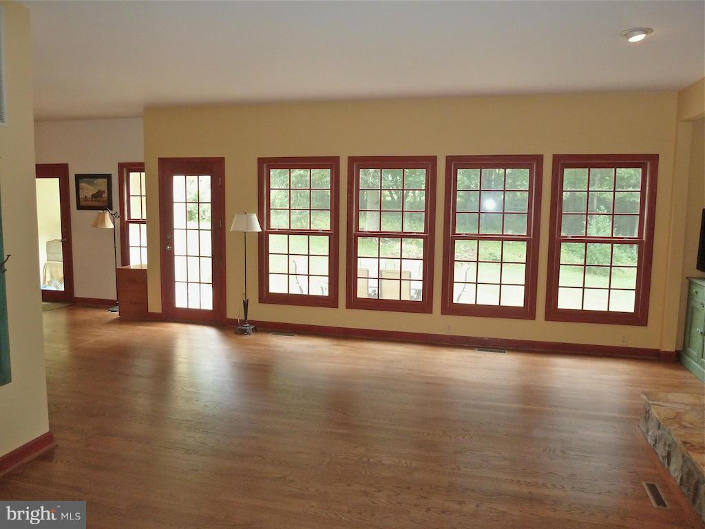 7035 Olinger Road Marshall, VA 20115 - Photo 14 of 25 a view of an empty room with wooden floor and a window