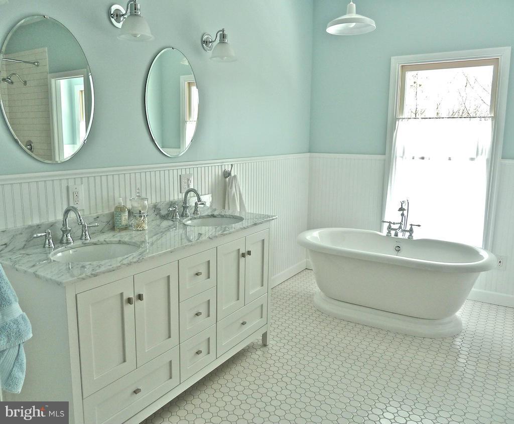 7035 Olinger Road Marshall, VA 20115 - Photo 17 of 25 a bathroom with a double vanity sink and a mirror