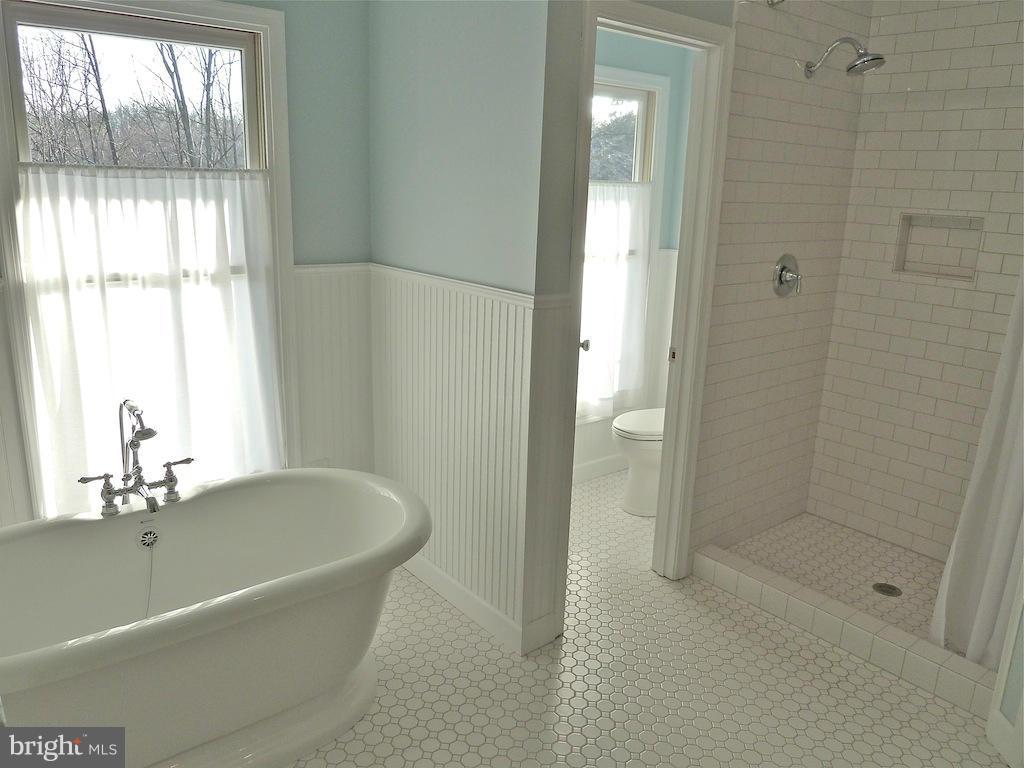 7035 Olinger Road Marshall, VA 20115 - Photo 18 of 25 a white bath tub sitting next to a shower