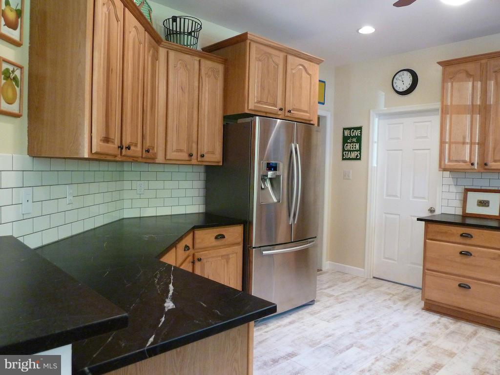 7035 Olinger Road Marshall, VA 20115 - Photo 9 of 25 a kitchen with stainless steel appliances granite countertop a refrigerator and a stove