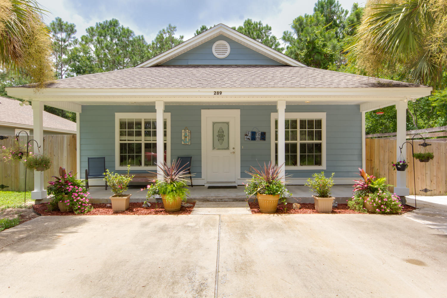289 South 2nd Street Santa Rosa Beach, FL 32459 - Photo 18 of 22 a front view of a house with a yard and potted plants