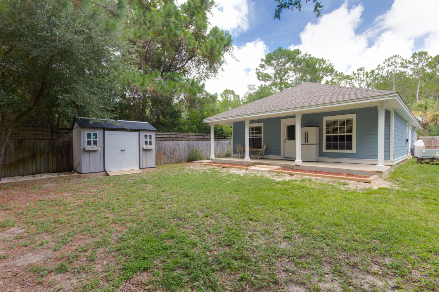 289 South 2nd Street Santa Rosa Beach, FL 32459 - Photo 19 of 22 a house with green field in front of it
