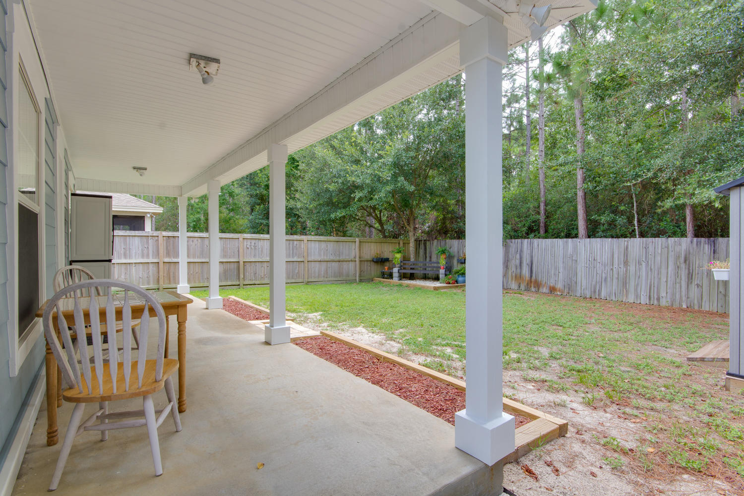 289 South 2nd Street Santa Rosa Beach, FL 32459 - Photo 20 of 22 a view of a chair and table in the backyard