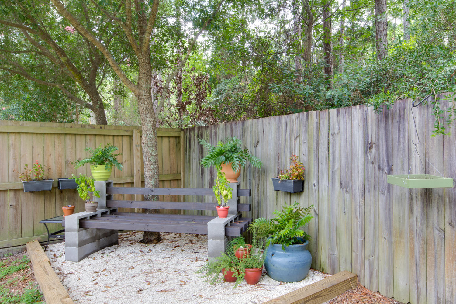289 South 2nd Street Santa Rosa Beach, FL 32459 - Photo 22 of 22 a view of a backyard with chairs potted plants and wooden fence