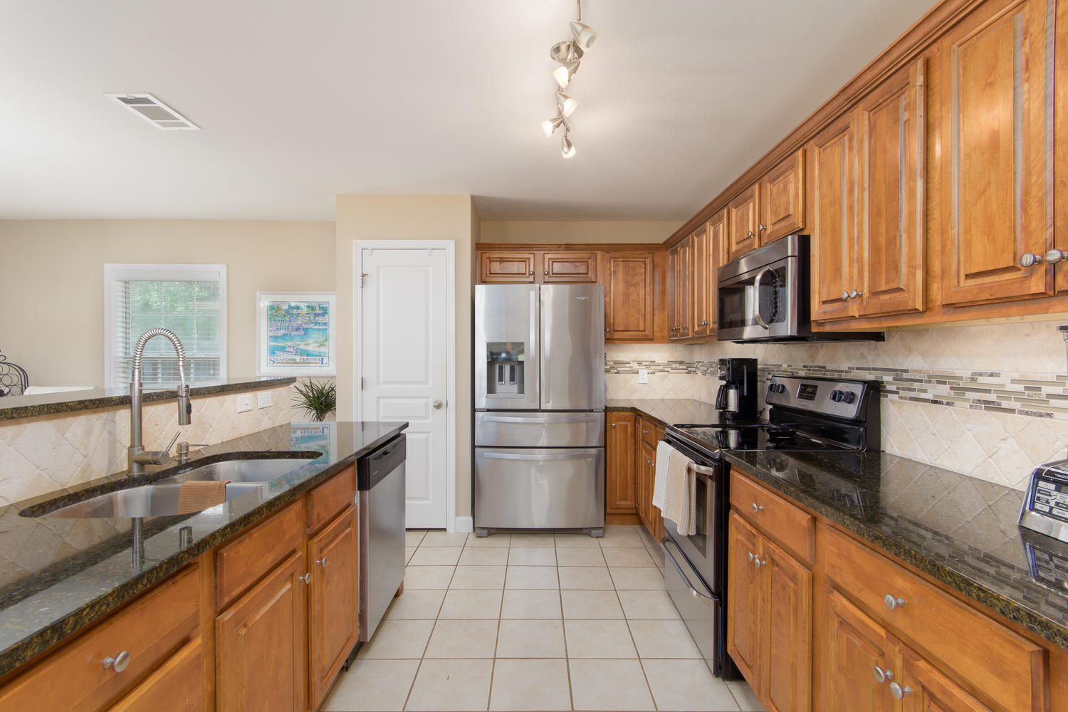 289 South 2nd Street Santa Rosa Beach, FL 32459 - Photo 5 of 22 a kitchen with stainless steel appliances granite countertop a sink stove and refrigerator