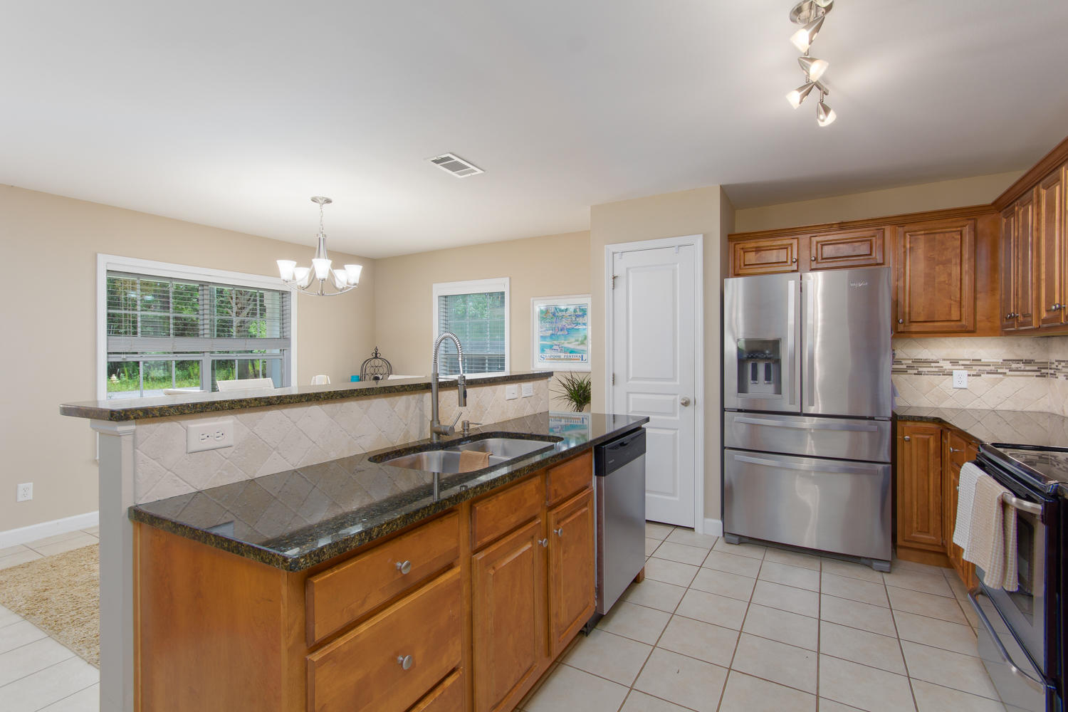 289 South 2nd Street Santa Rosa Beach, FL 32459 - Photo 9 of 22 a kitchen with stainless steel appliances granite countertop a sink stove and refrigerator