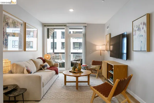 a living room with furniture a large window and a flat screen tv