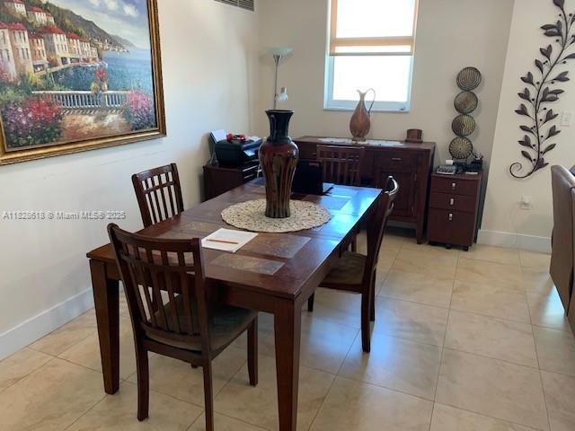 31 Southeast 5th Street, Unit 2601 Miami, FL 33131 - Photo 13 of 41 a view of a dining room with furniture and chandelier