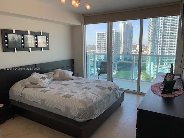 31 Southeast 5th Street, Unit 2601 Miami, FL 33131 - Photo 14 of 41 a bedroom with a bed and a large window