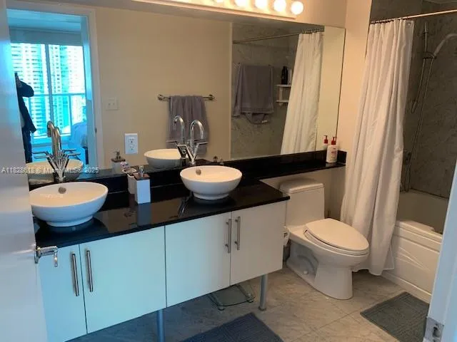 a bathroom with a shower and a toilet