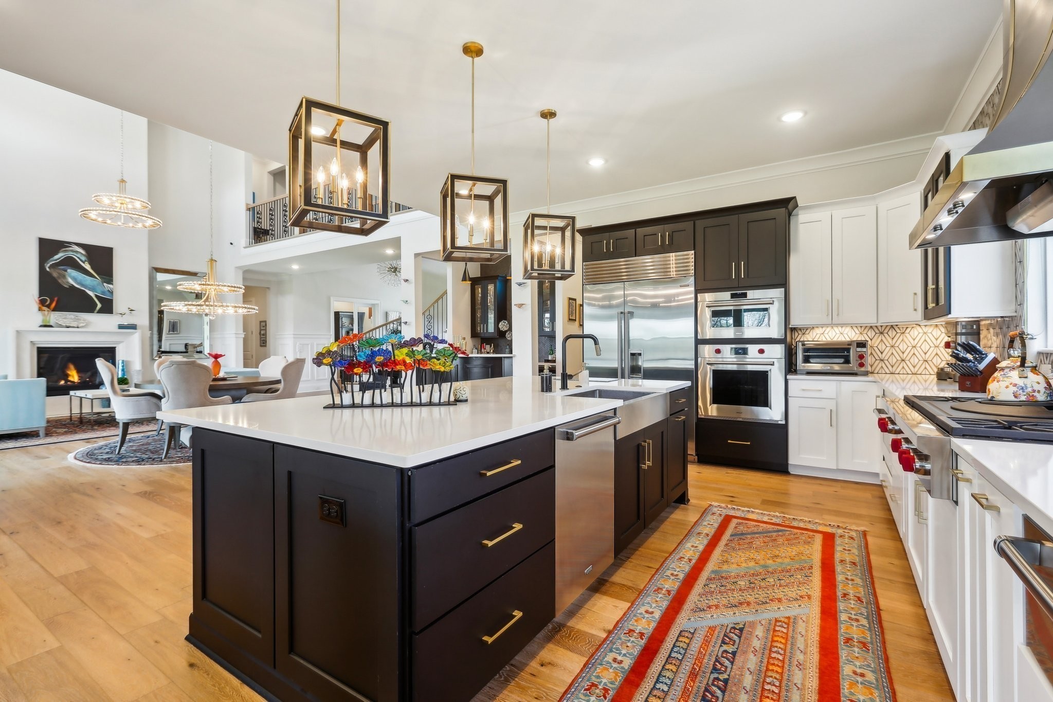 6004 Lookaway Circle Franklin, TN 37067 - Photo 36 of 80 a large kitchen with stainless steel appliances kitchen island granite countertop a stove top oven a sink dishwasher and white cabinets with wooden floor