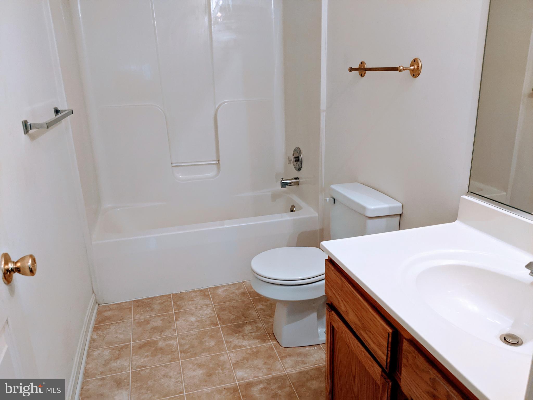 403 Perrys Corner Road Grasonville, MD 21638 - Photo 8 of 10 a bathroom with a sink a toilet and shower