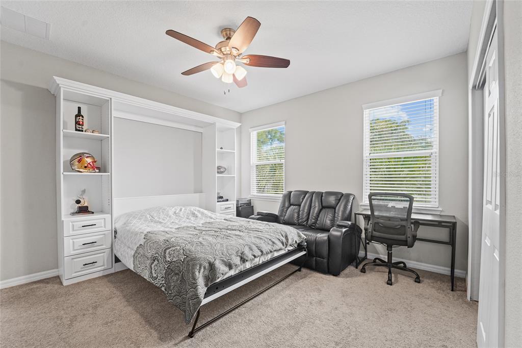 8903 Arabella Lane Seminole, FL 33777 - Photo 29 of 47 a bedroom with a bed and a chandelier