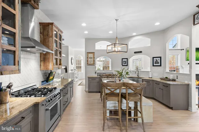 a kitchen with stainless steel appliances granite countertop a stove and cabinets