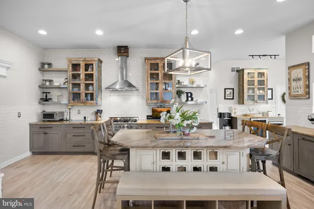 a kitchen with stainless steel appliances granite countertop a refrigerator and a stove