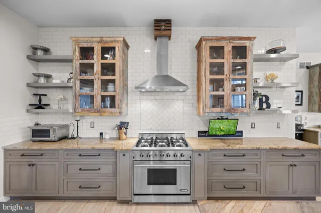 a view of a dining room with furniture and a chandelier