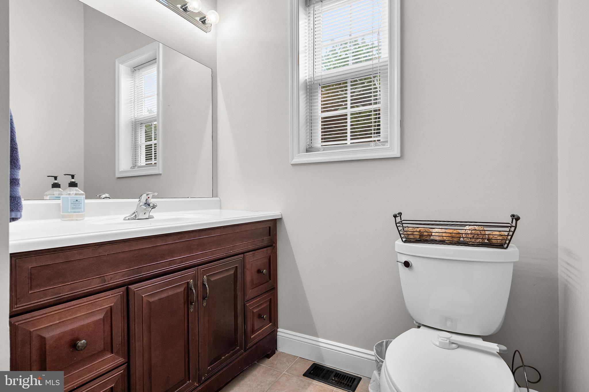 205 Sherwin Road Mullica Hill, NJ 08062 - Photo 29 of 70 a bathroom with a toilet a sink and mirror