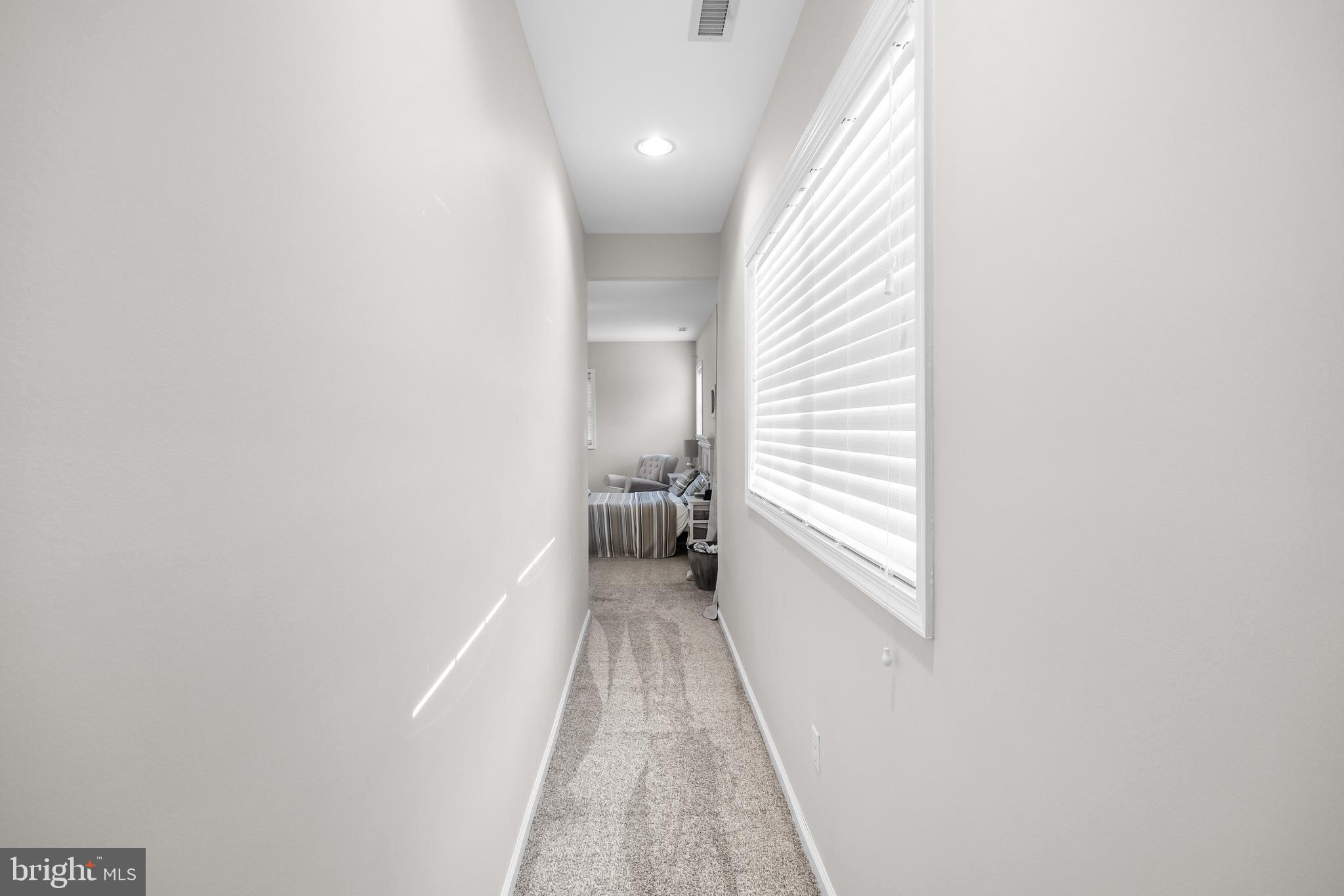 205 Sherwin Road Mullica Hill, NJ 08062 - Photo 41 of 70 a view of a hallway with wooden floor and a bathroom