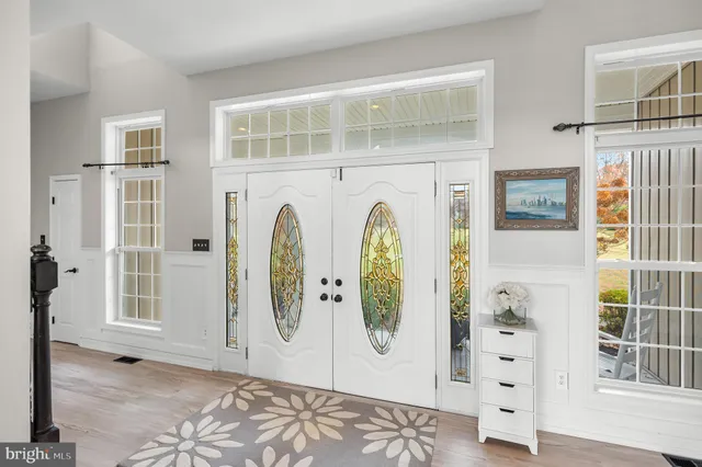 a view of an entryway with wooden floor and windows
