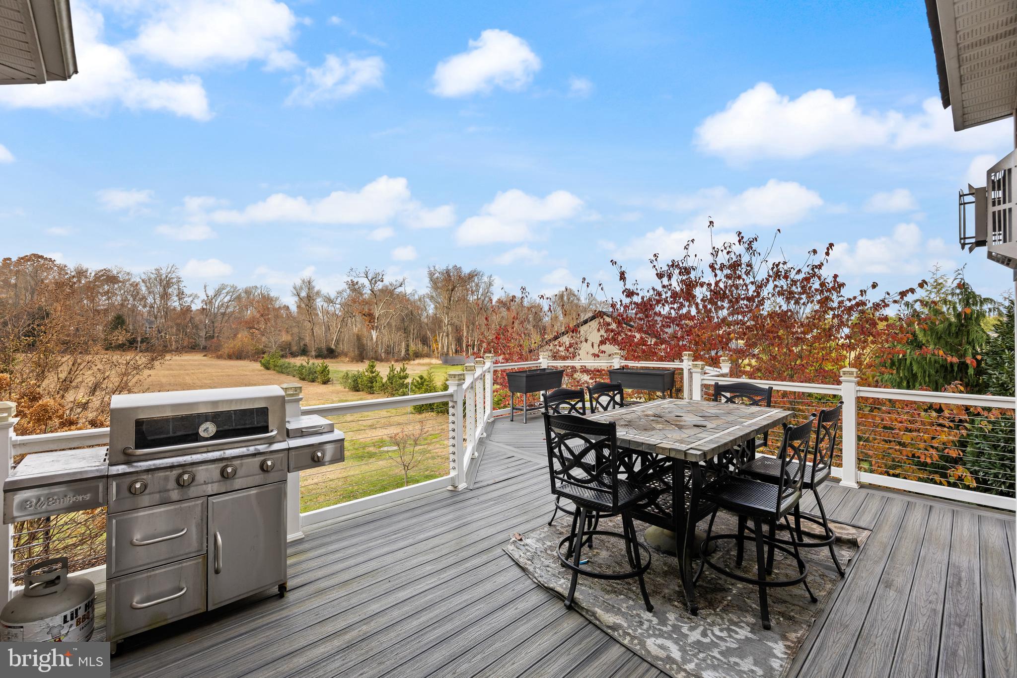 205 Sherwin Road Mullica Hill, NJ 08062 - Photo 56 of 70 a view of a roof deck with table and chairs a barbeque with wooden floor and fence