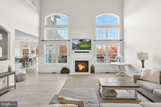 a living room with furniture a large window and a fireplace