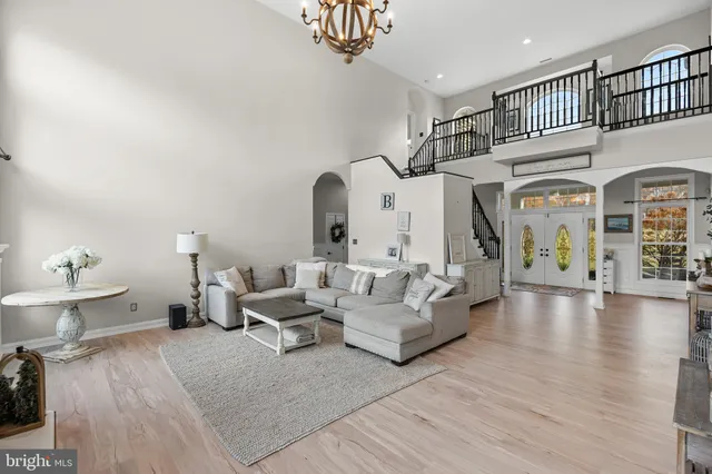 a living room with furniture and a chandelier