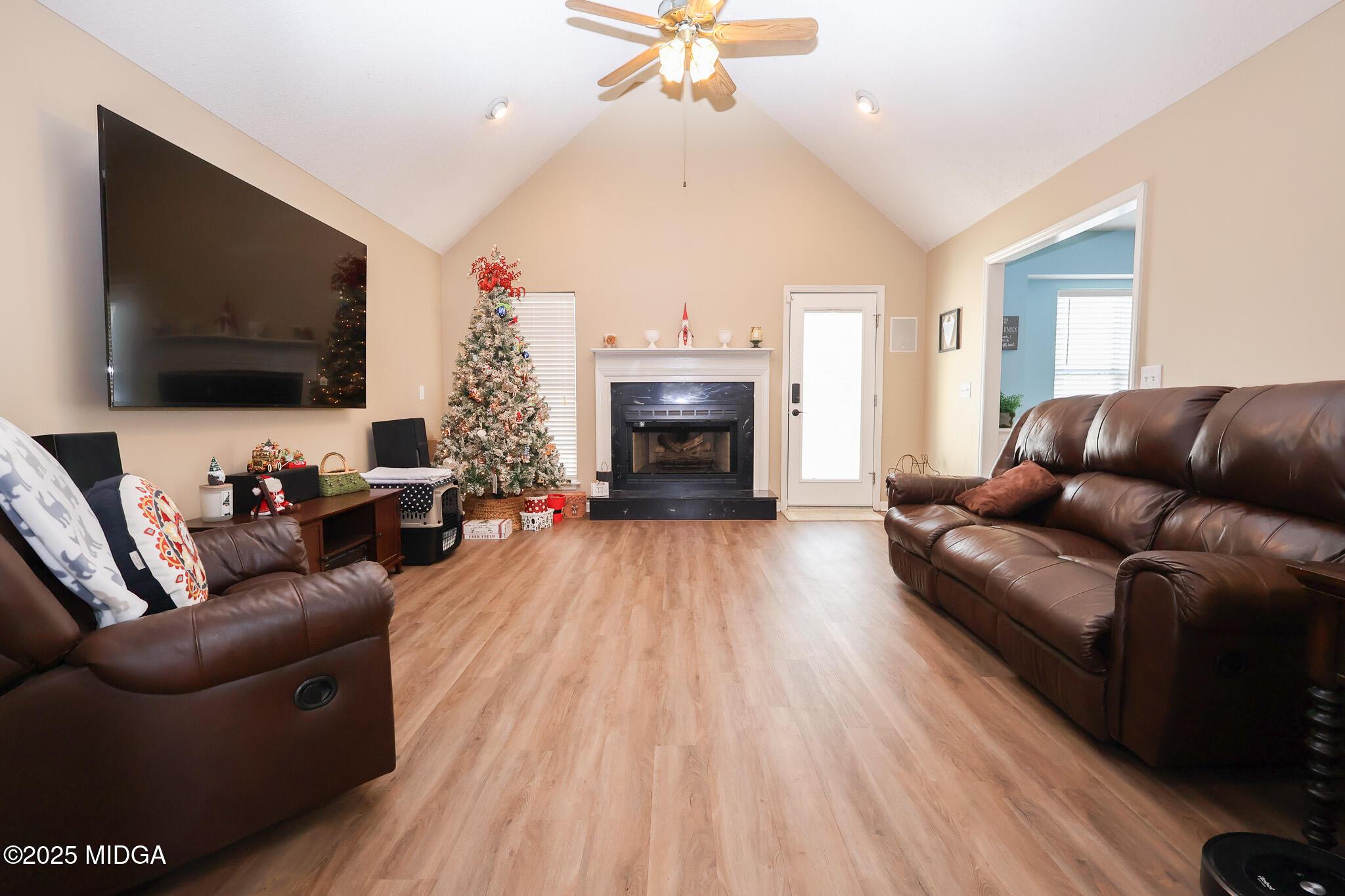215 Stonefield Circle Macon, GA 31216 - Photo 4 of 26 a living room with furniture a flat screen tv and a fireplace
