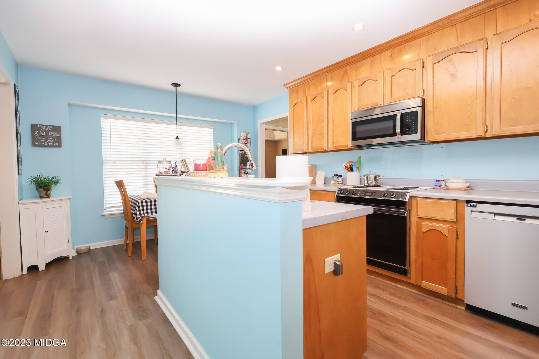 215 Stonefield Circle Macon, GA 31216 - Photo 7 of 26 a kitchen with stainless steel appliances granite countertop a refrigerator a stove top oven a sink dishwasher and white cabinets with wooden floor