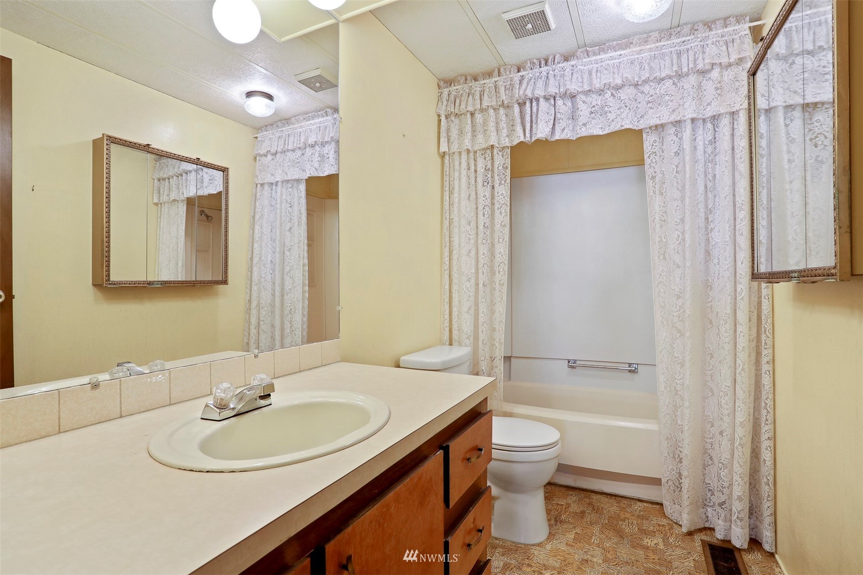 23627 Lake Drive East Bothell, WA 98021 - Photo 20 of 40 a bathroom with a sink a toilet and shower