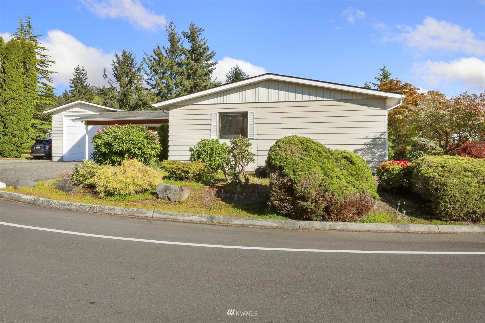 23627 Lake Drive East Bothell, WA 98021 - Photo 24 of 40 a front view of a house with a yard and potted plants