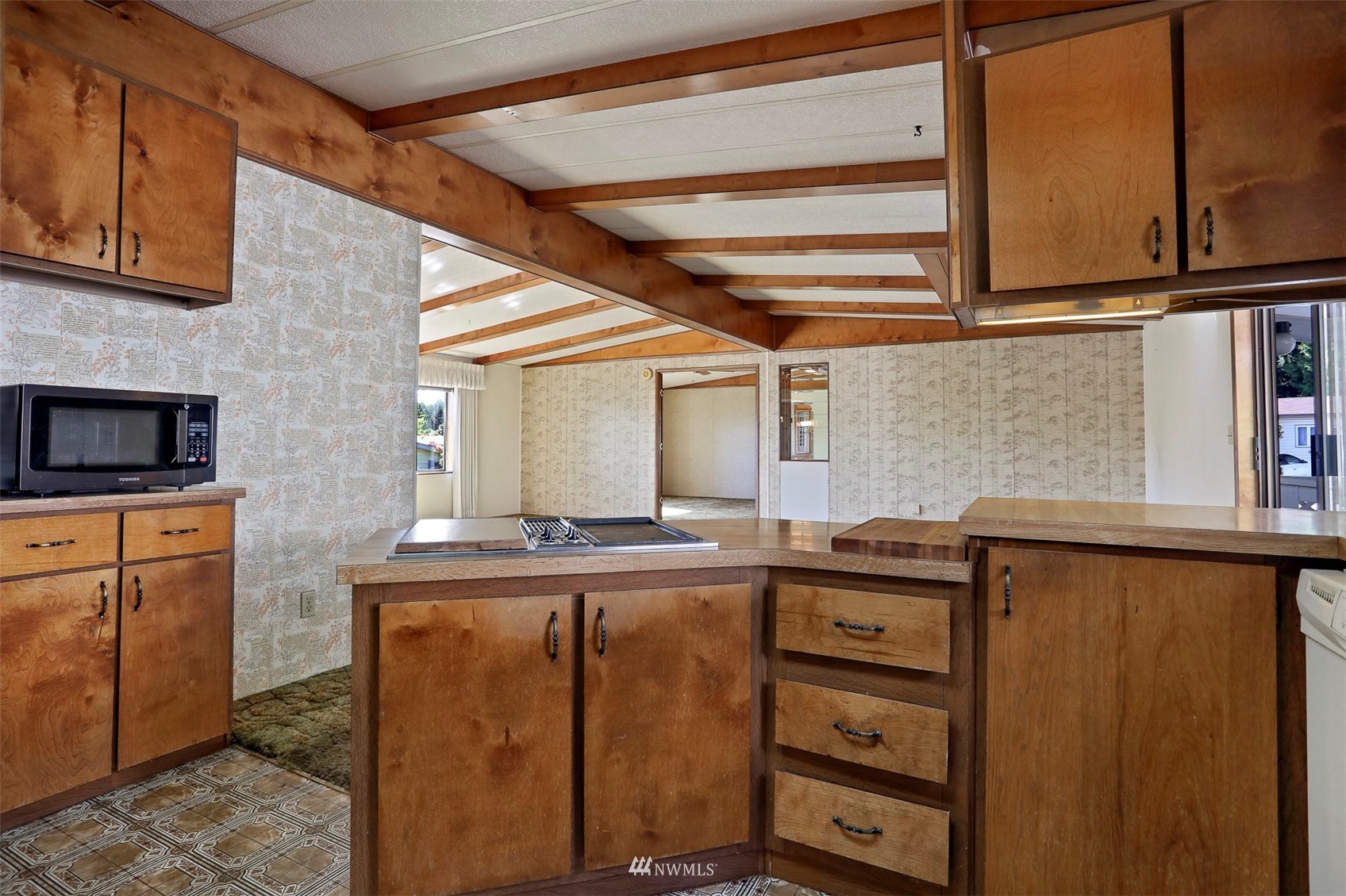 23627 Lake Drive East Bothell, WA 98021 - Photo 10 of 40 a kitchen with a cabinets and chairs