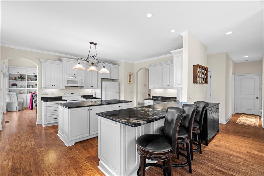 2191 Lakeview Parkway Villa Rica, GA 30180 - Photo 20 of 96 a kitchen with stainless steel appliances granite countertop a stove a sink a dining table and chairs