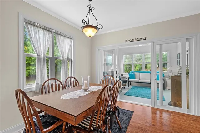 a living room with furniture flat screen tv and a large window
