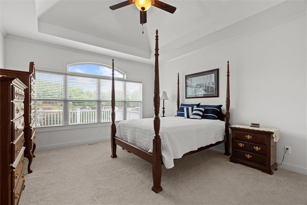 2191 Lakeview Parkway Villa Rica, GA 30180 - Photo 27 of 96 a spacious bedroom with a bed and a chandelier