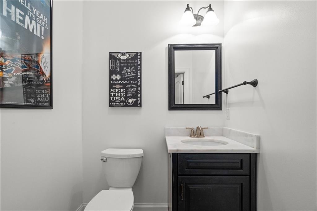 2191 Lakeview Parkway Villa Rica, GA 30180 - Photo 39 of 96 a bathroom with a toilet a sink and mirror