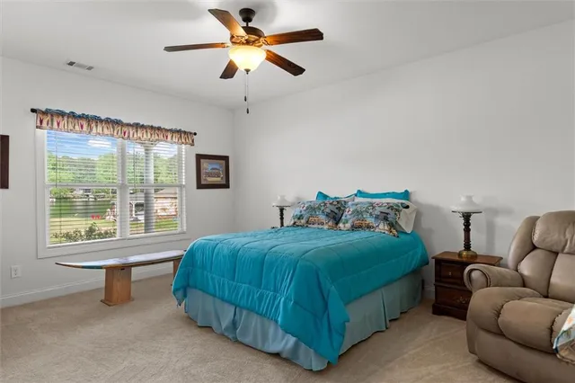 an aerial view of a house with a yard and lake view