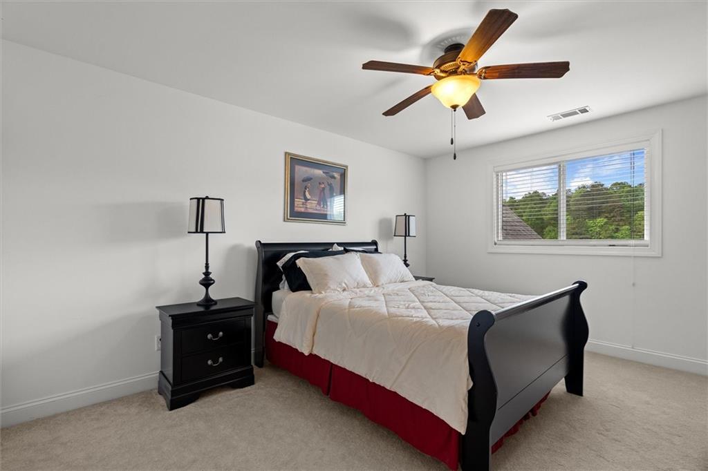 2191 Lakeview Parkway Villa Rica, GA 30180 - Photo 44 of 96 a bedroom with a bed and a chandelier