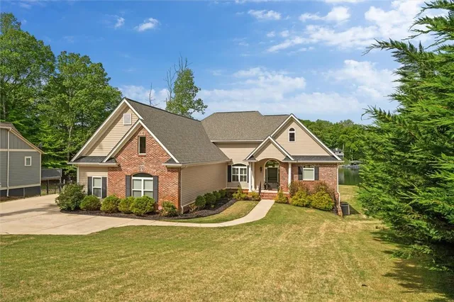 a front view of a house with a garden