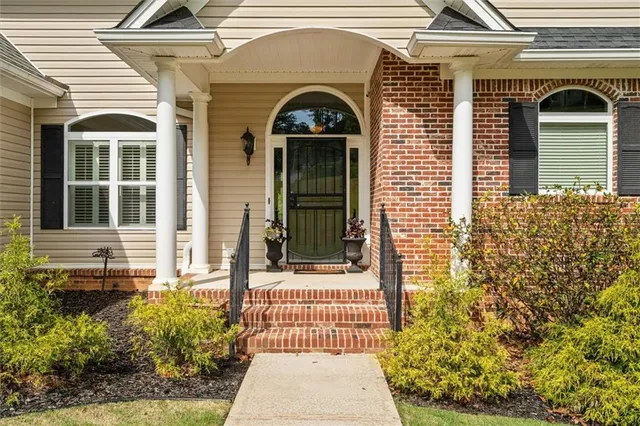 a living room with furniture a flat screen tv and a large window