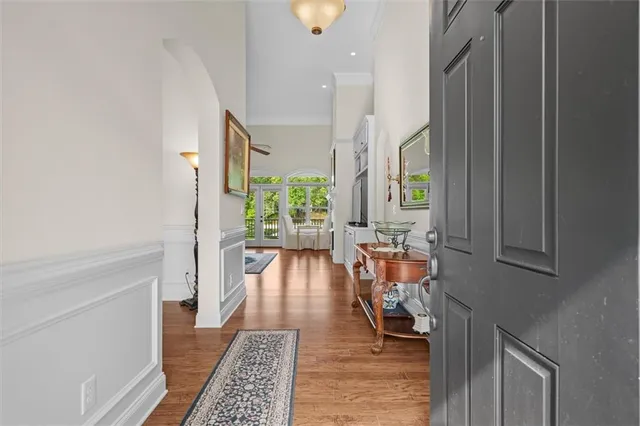 a living room with furniture a flat screen tv and a table