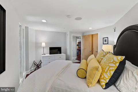 a bedroom with a bed and flat screen tv