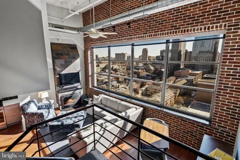 a bedroom with furniture and wooden floor