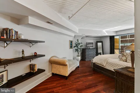 a bedroom with a bed and flat screen tv