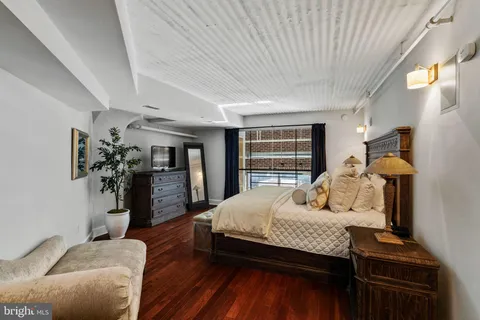 a bedroom with a bed and a couch