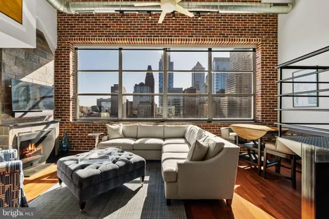 a view of a balcony with couch and chairs