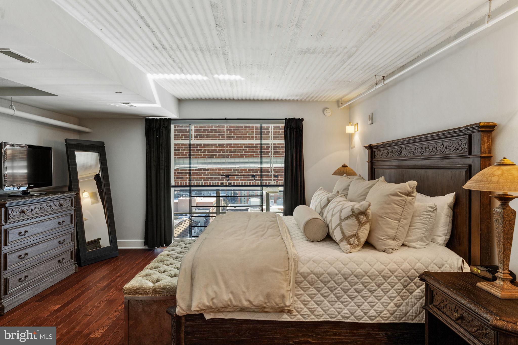 2200-28 Arch Street, Unit 1205 Philadelphia, PA 19103 - Photo 21 of 48 a bedroom with a bed and flat screen tv