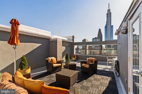 a terrace of a house with outdoor seating