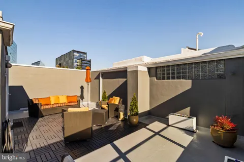a living room with furniture and floor to ceiling window