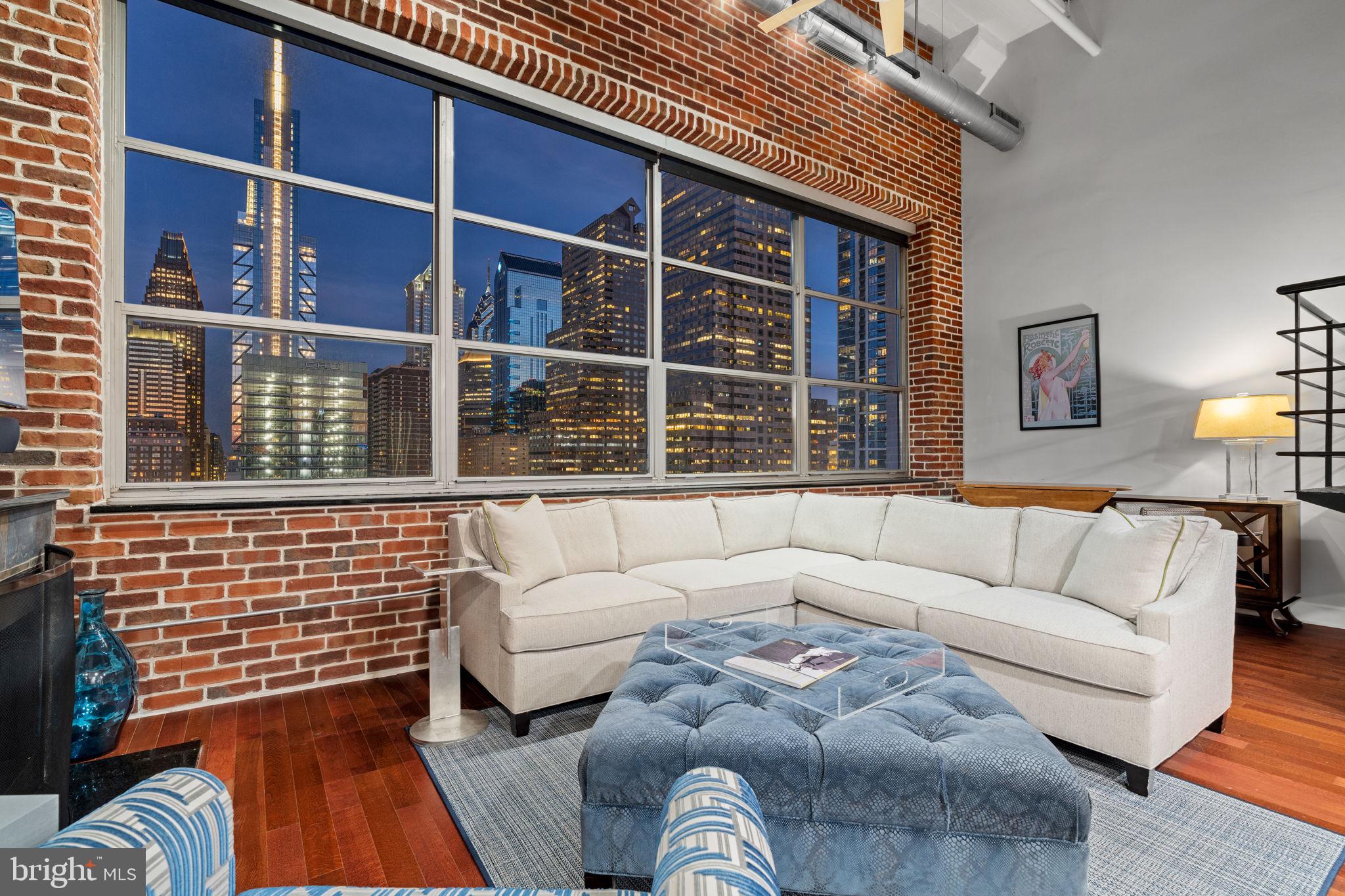 2200-28 Arch Street, Unit 1205 Philadelphia, PA 19103 - Photo 30 of 48 a living room with furniture and a window