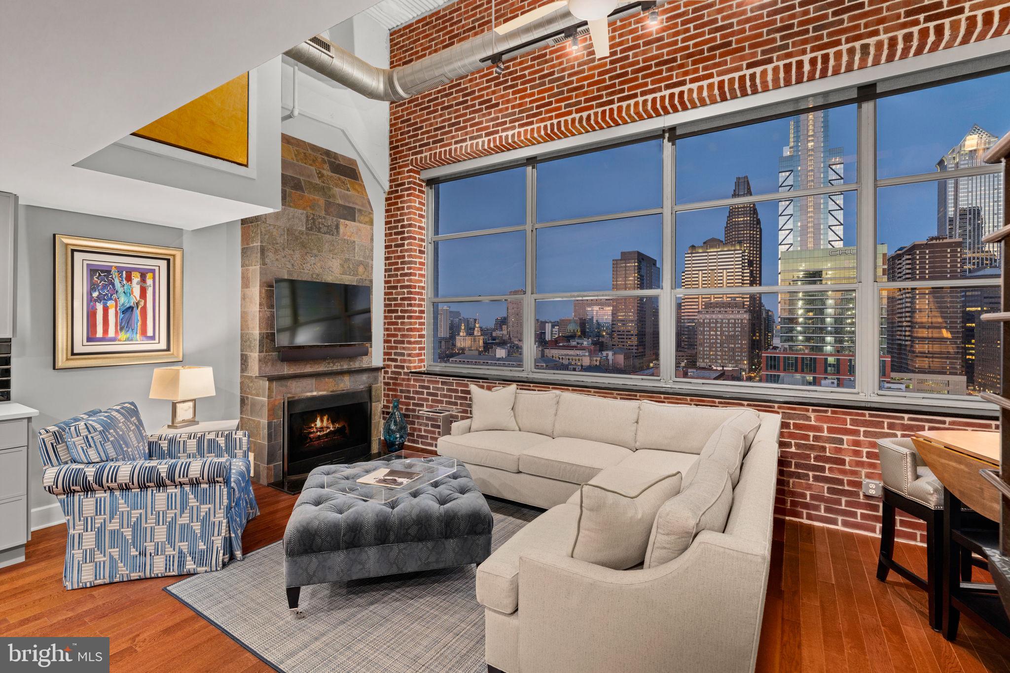 2200-28 Arch Street, Unit 1205 Philadelphia, PA 19103 - Photo 33 of 48 a living room with furniture and a fireplace